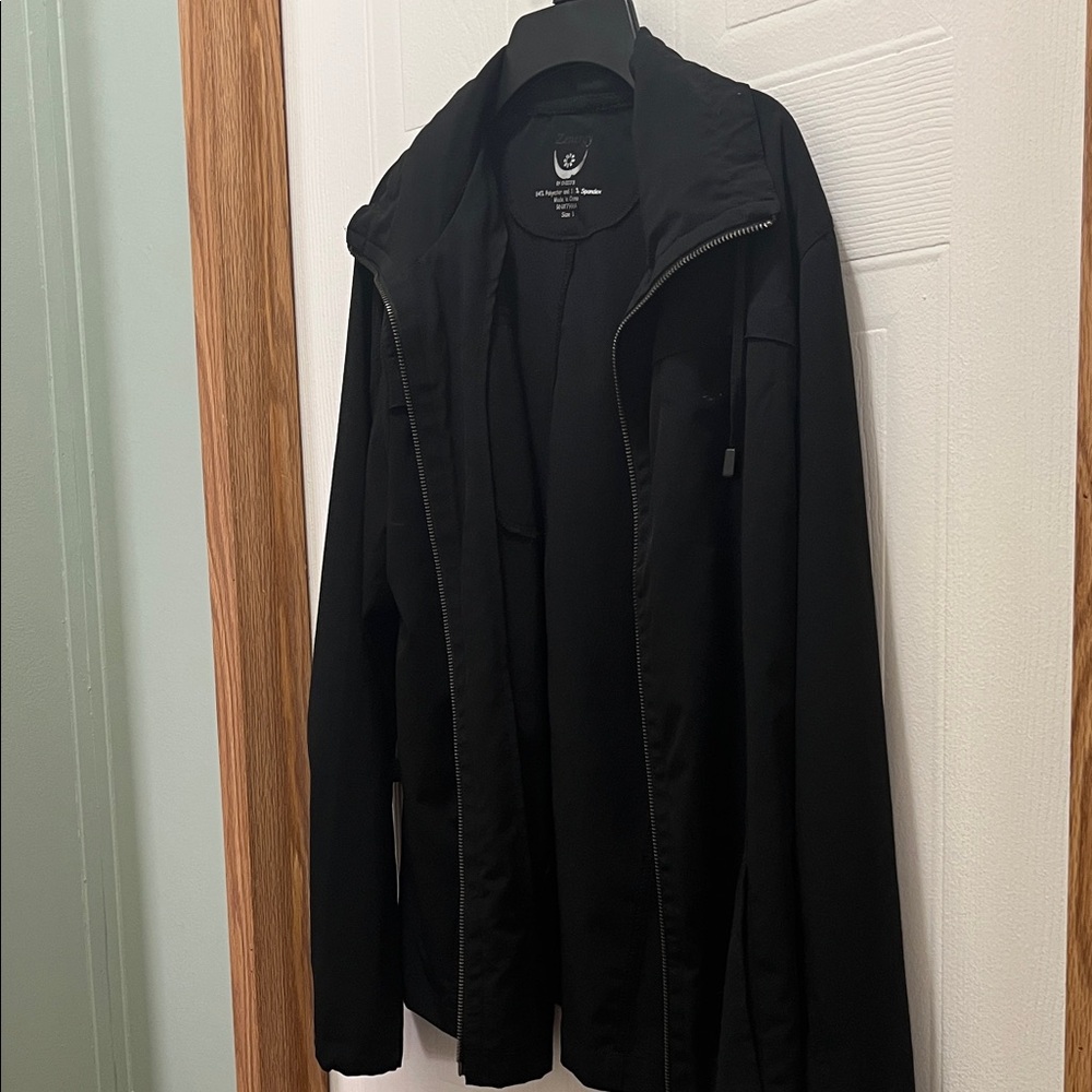 Women’s black jacket. Lightweight jacket. Has hood hidden in back collar